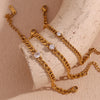 Gold charm bracelet featuring round water drop zircon charms displayed on a light background.