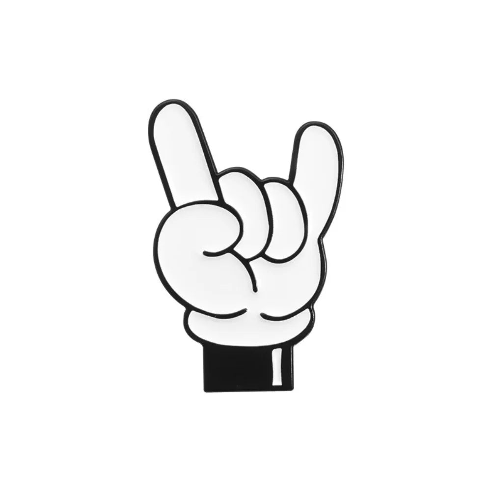 A white enamel pin depicting a cartoon finger gesture with the thumb and index finger touching to form a heart shape.