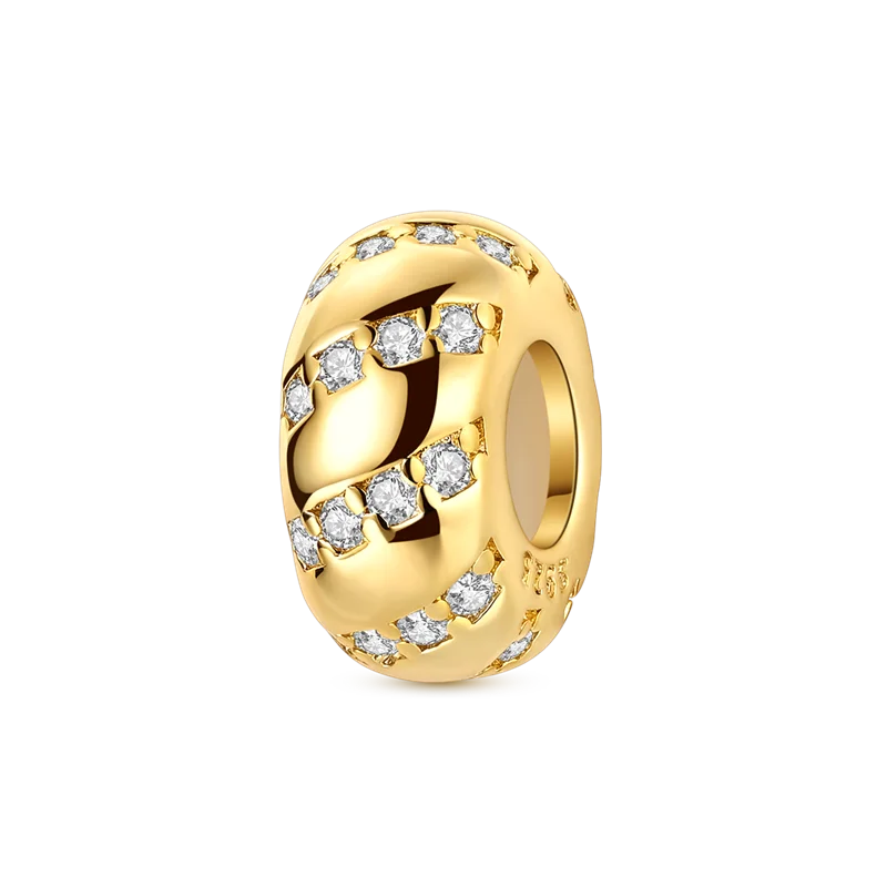 A gold-toned charm bracelet featuring devil's eye charms and small diamonds.