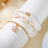 Gold beaded starfish conch anklet bracelet on a white wrist.