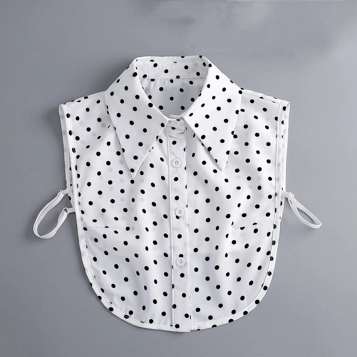 White blouse with black polka dots featuring a false collar and detachable neckline.