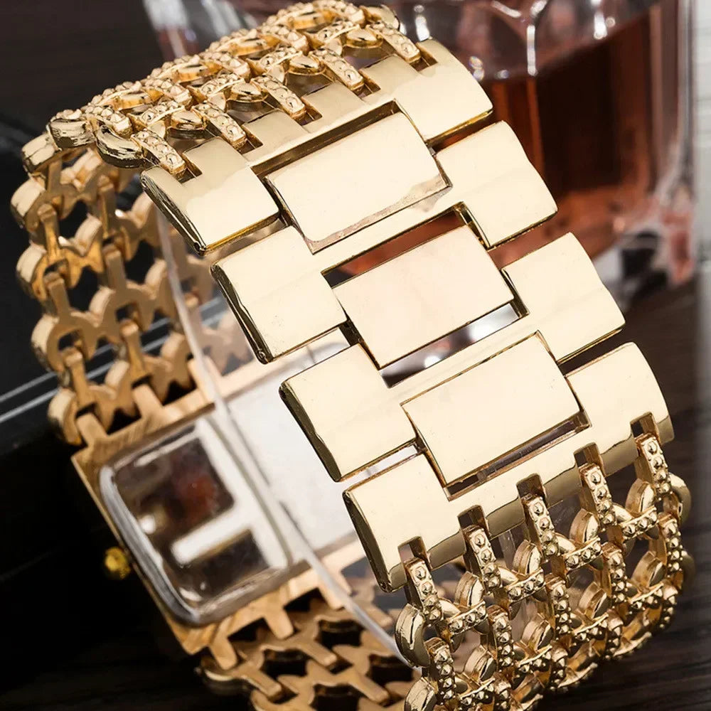 A close-up of a fashion quartz diamond watch with a gold stainless steel bracelet displayed on a dark surface.