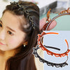 Close-up of a woman wearing a multi-layer braided hair headband clip with orange accents.