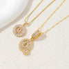 Gold-toned necklace set featuring CZ crystal pendants shaped like letters, displayed on a light background.