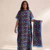 A woman models an elegant long silk blend cover-up robe dress featuring a dark blue and orange patterned fabric.
