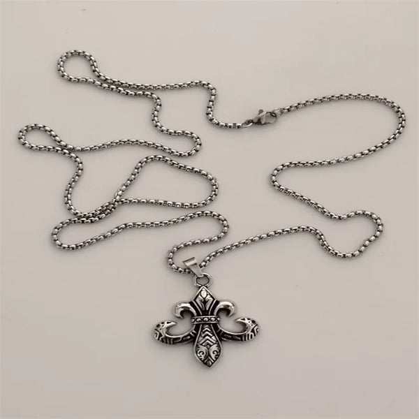 Silver chain necklace with an ornate cross pendant