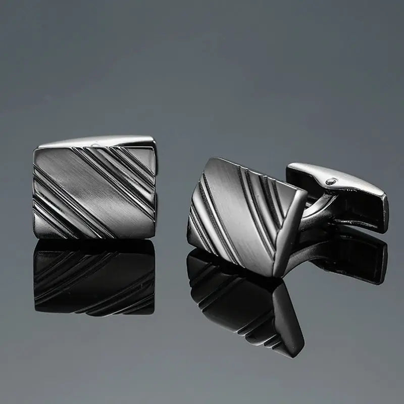 A pair of men's classic copper square cufflinks with a textured, striped design shown against a dark gray background.