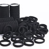 A pile of black elastic hair bands and hair ties.