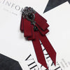 A deep burgundy velvet bow tie with black rhinestone accents shown against a white background.