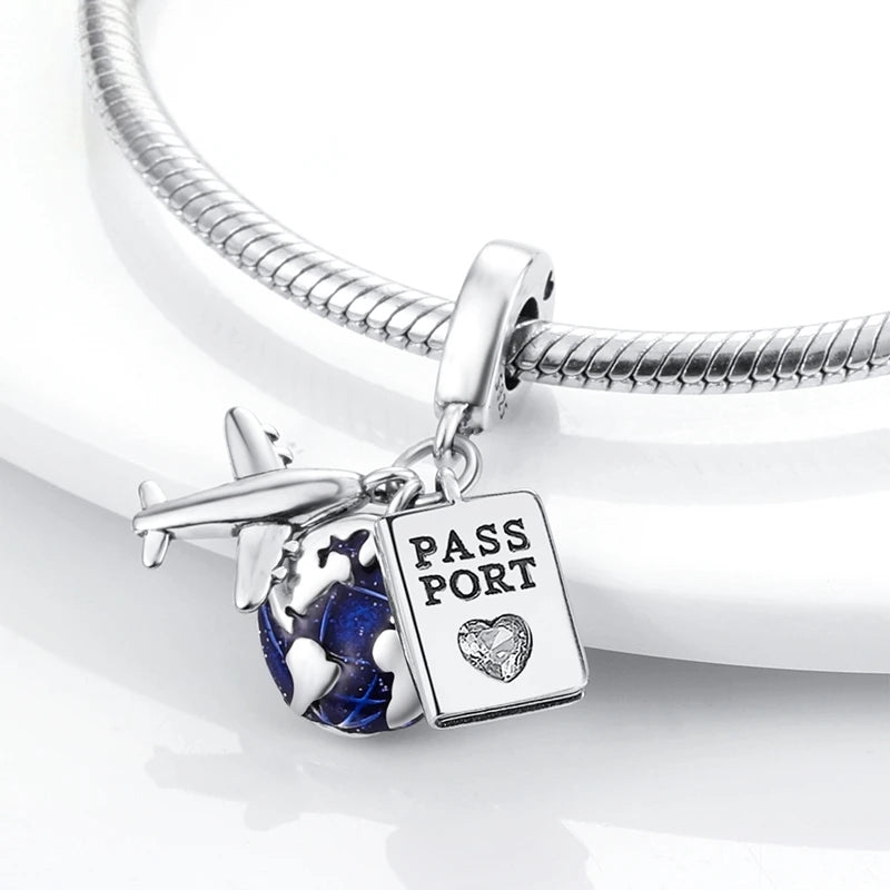 Sterling silver charm bracelet featuring a pass port pendant with a heart and devil's eye stones