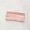 A pink knitted sports headband with vertical ribbing.