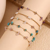 Multiple strands of 18K gold plated crushed stone foot chains featuring various colored stones like amethyst and turquoise.