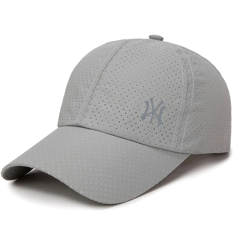 A light gray unisex adjustable baseball cap with a perforated fabric and a stylized monogram on the front.