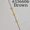A close-up of a brown traditional Ethiopian head chain featuring gold-colored decorative elements.