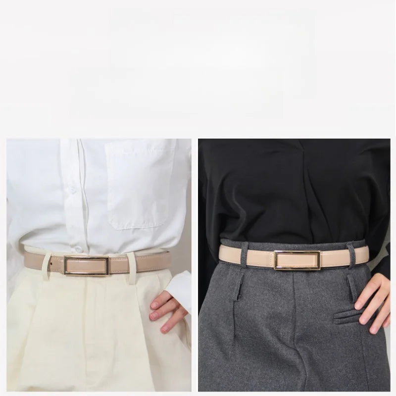 A close-up of a tan faux leather belt worn with light trousers and a black blouse.