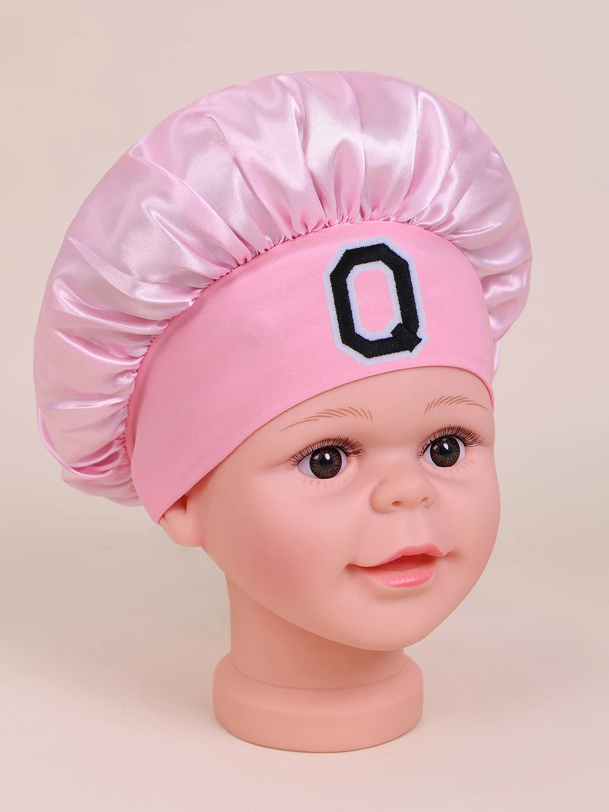 Pink A-Z letter sleep cap for kids with a ruffled toque