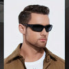 A man wearing black sporty polycarbonate sunglasses and a brown collared shirt.