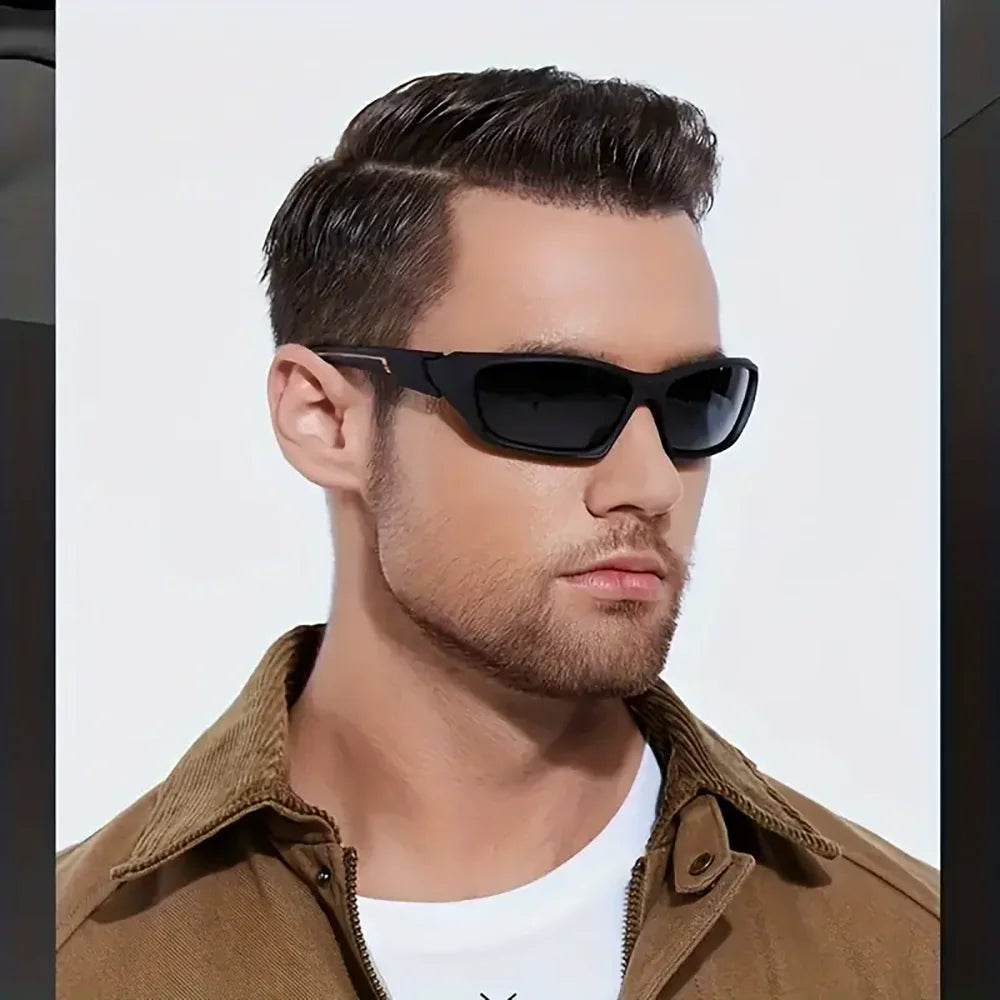 A man wearing black sporty polycarbonate sunglasses and a brown collared shirt.