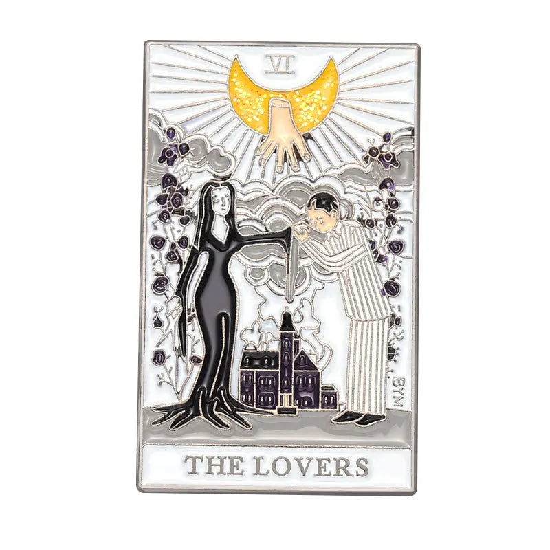 A silver enamel pin featuring a tarot card design with a golden sun and two figures.