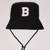 Black sun hat with a large white letter B embroidered on the front
