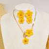 A gold-toned necklace featuring a cluster of yellow floral pendants displayed on a white mannequin.