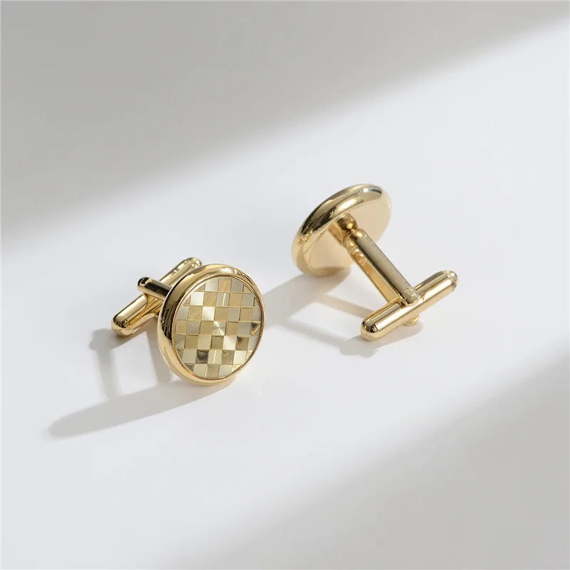 A pair of elegant gold-toned cufflinks featuring a checkered pattern and a bar design.