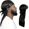 A man wearing a black silky durag shower cap bandana and a white shirt.
