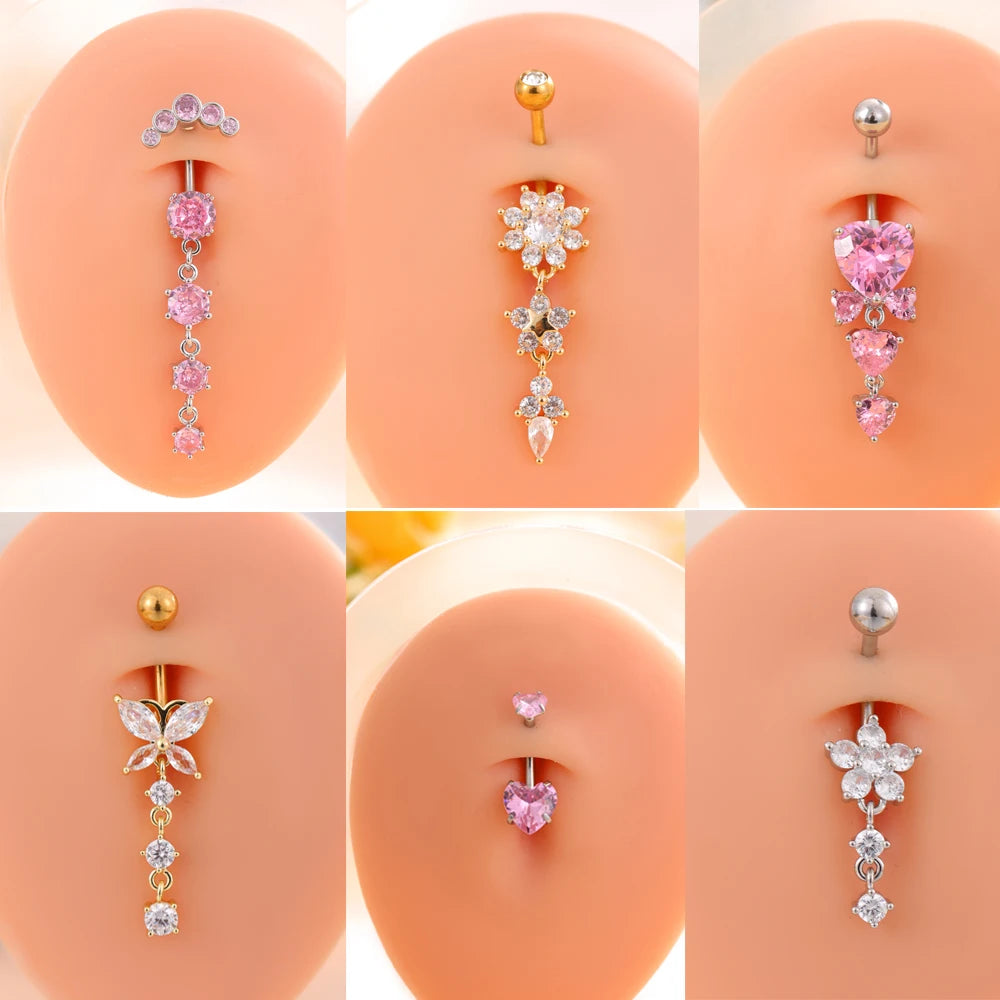 A set of five gold stainless steel dangled belly button rings featuring various floral and heart designs.