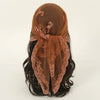 A close-up of a brown floral embroidered lace bandana headscarf tied around dark hair.
