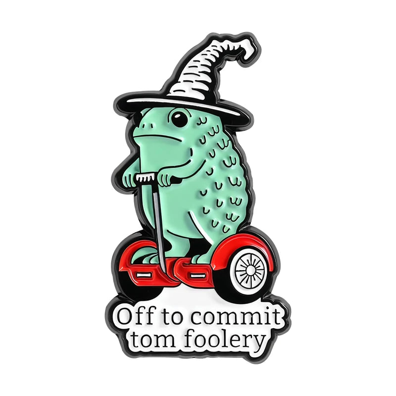 An enamel pin featuring a whimsical frog wizard with a pointed hat and a staff.