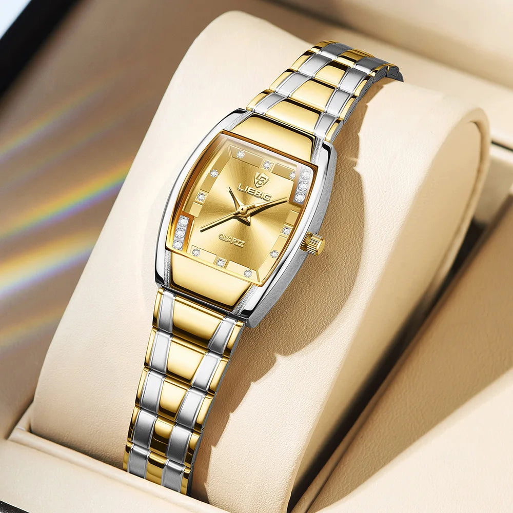 A gold and silver minimalist quartz wristwatch is displayed on a light beige background.