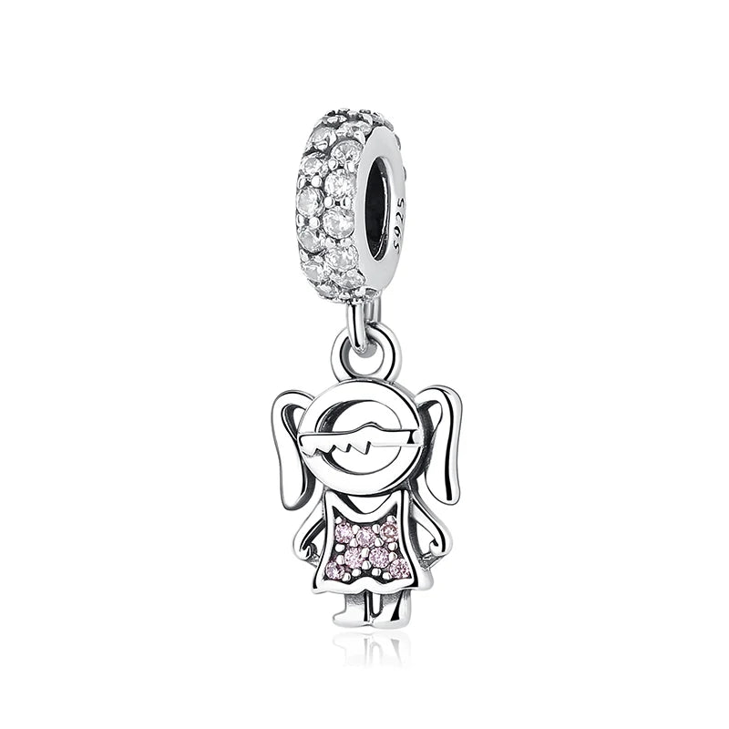 A silver family tree charm necklace featuring a detailed tree design and a small pink gemstone.