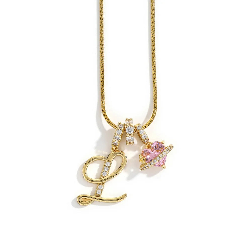 Gold alphabet flower pendant necklace with a heart charm on a gold chain