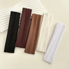 A collection of solid fabric headbands in black, maroon, brown, and cream are displayed on a light background.