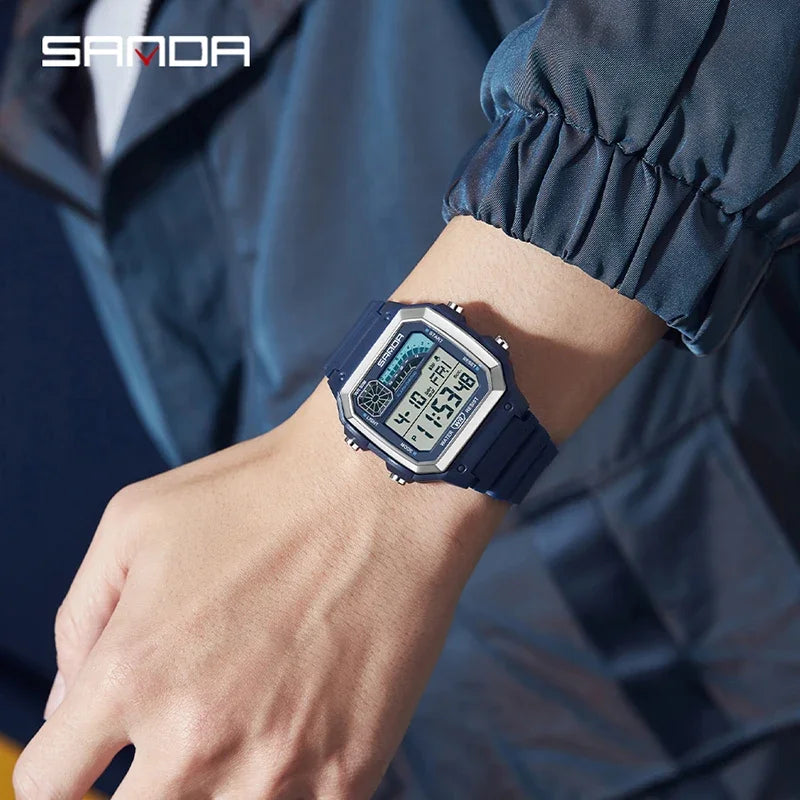 A close-up of a dark blue sport digital wristwatch with a metal bezel worn on a person's wrist.