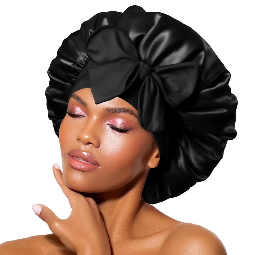 A woman wearing a black satin sleeping bonnet tied in a large bow.