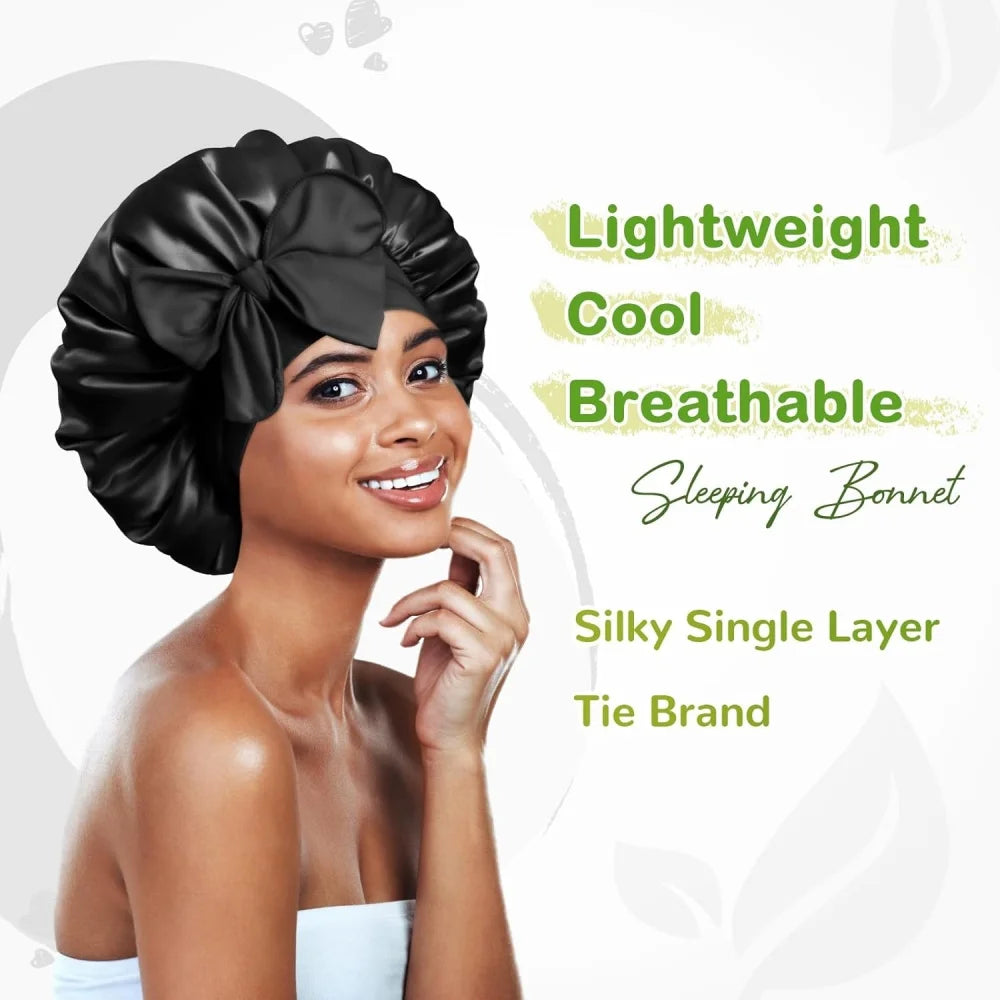 A woman wearing a black satin sleeping bonnet with an adjustable tie band.