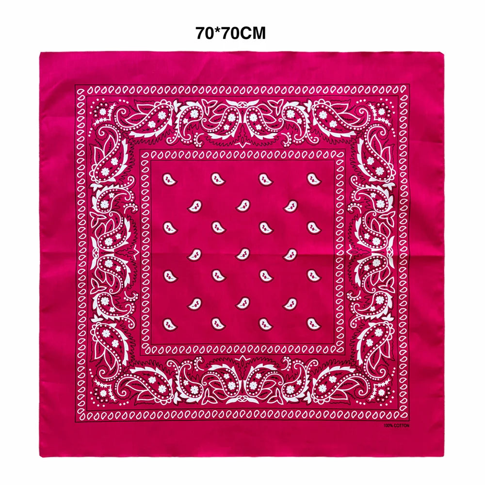 A vibrant magenta square scarf featuring intricate white paisley embroidery and borders.