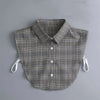 A grey plaid shirt with a collar and detachable necklines is displayed on a light gray background.