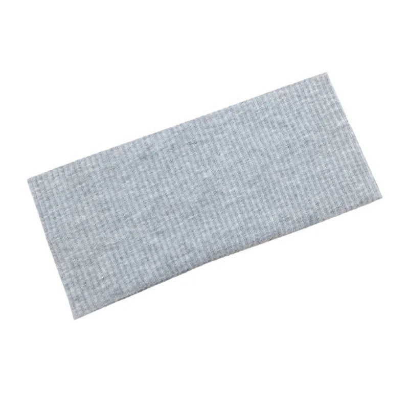 A gray knitted sports headband for yoga and gym