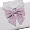 A white dress shirt with a lavender butterfly ribbon tie set folded and displayed.