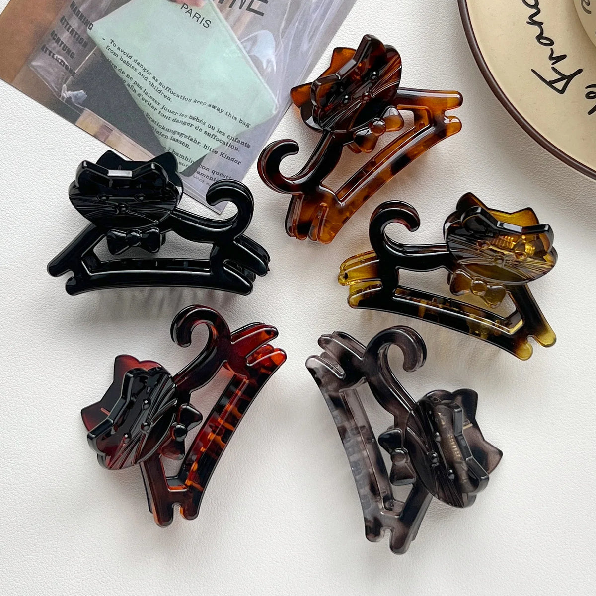 A set of cute cartoon animal hair clips in various shades of amber and brown.