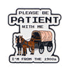 Enamel pin featuring text PLEASE BE PATIENT WITH ME and an illustration of a horse-drawn carriage.