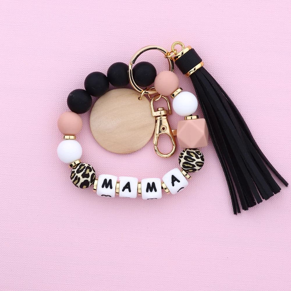 Leopard silicone bead key chain featuring black and pink beads and a mama charm