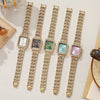 Five gold-toned rhinestone quartz wristwatches displayed on a light background.