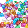 A collection of multicolor dreadlock hair rings and accessories in various shades of purple, pink, green, and gold.
