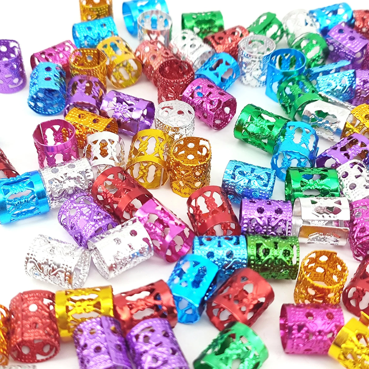 A collection of multicolor dreadlock hair rings and accessories in various shades of purple, pink, green, and gold.