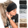 A woman wearing a black boho knot headwrap hair band on her hair, with a gray shirt visible.