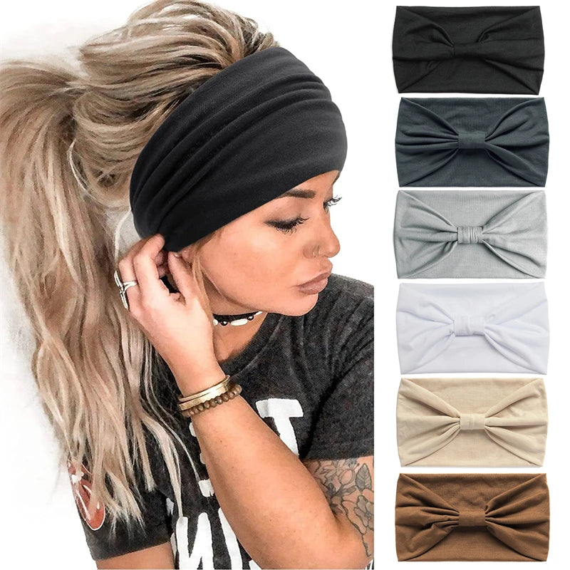 A woman wearing a black boho knot headwrap hair band on her hair, with a gray shirt visible.