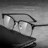 A pair of black anti-blue light clear wireframe eyeglasses resting on a dark leather case.
